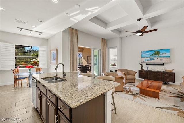 kitchen with open floor plan, coffered ceiling, visible vents, and a sink