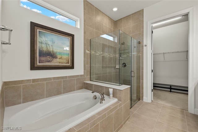 bathroom featuring a walk in closet, a garden tub, recessed lighting, a shower stall, and tile patterned flooring