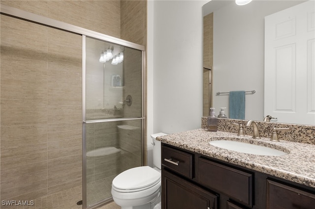 full bath with vanity, toilet, and a stall shower