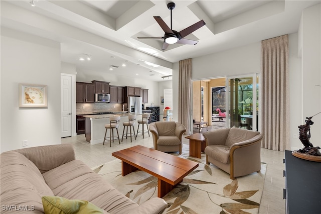 living area featuring a towering ceiling, a ceiling fan, recessed lighting, and coffered ceiling