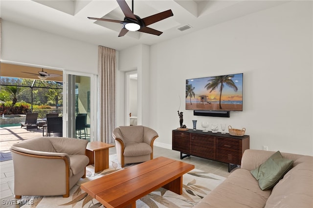 living area featuring light tile patterned floors, visible vents, ceiling fan, and a sunroom