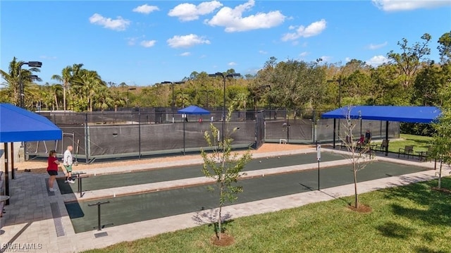 surrounding community with a lawn and fence