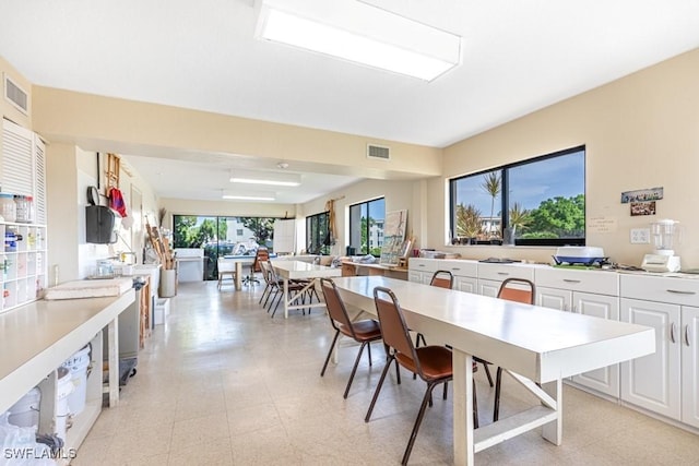 dining space with light floors and visible vents