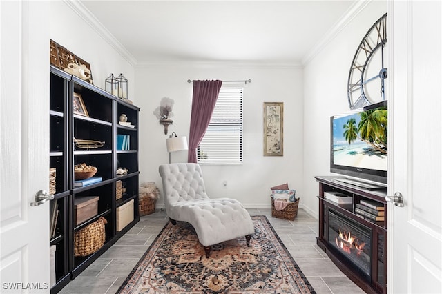 living area featuring wood finish floors, baseboards, and ornamental molding