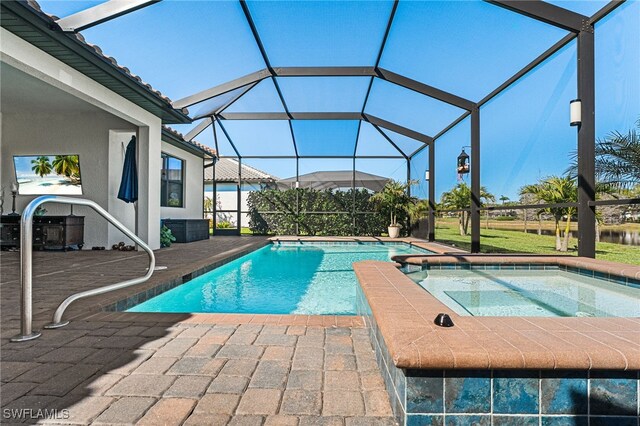 view of swimming pool with glass enclosure, a pool with connected hot tub, and a patio area