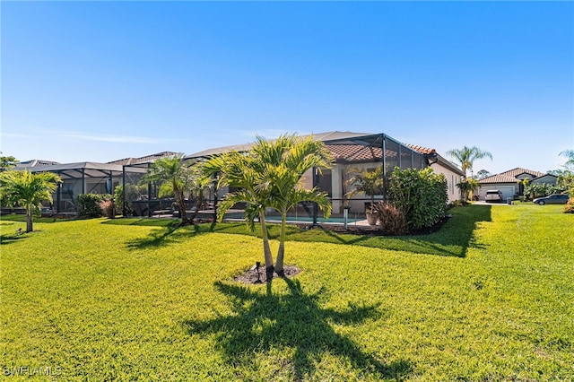 view of yard with a lanai and an outdoor pool