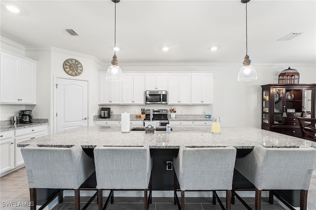 kitchen featuring visible vents, appliances with stainless steel finishes, and ornamental molding