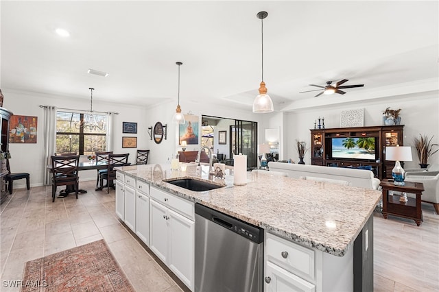 kitchen featuring a sink, open floor plan, dishwasher, light stone counters, and a kitchen island with sink