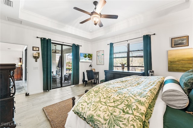 bedroom featuring visible vents, a raised ceiling, crown molding, and access to outside