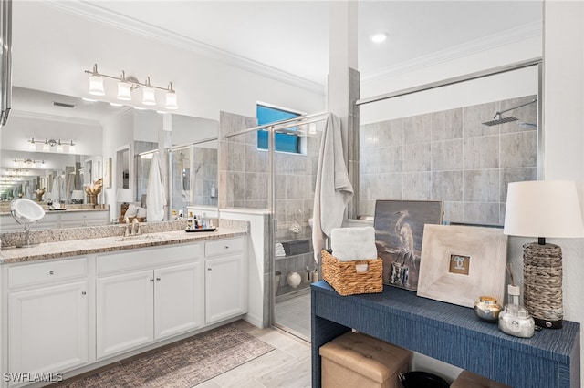 full bathroom with visible vents, a shower stall, vanity, and crown molding