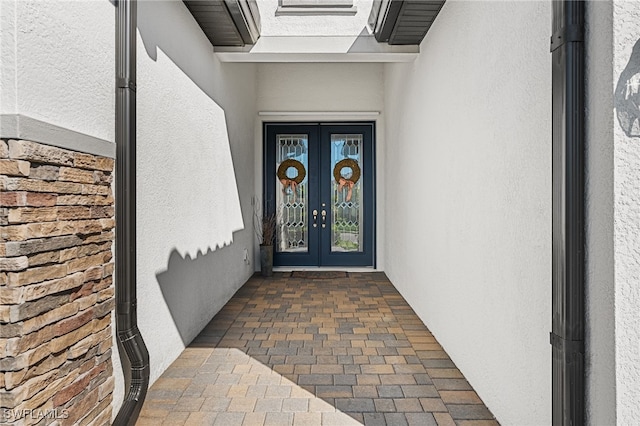 doorway to property with french doors and stucco siding