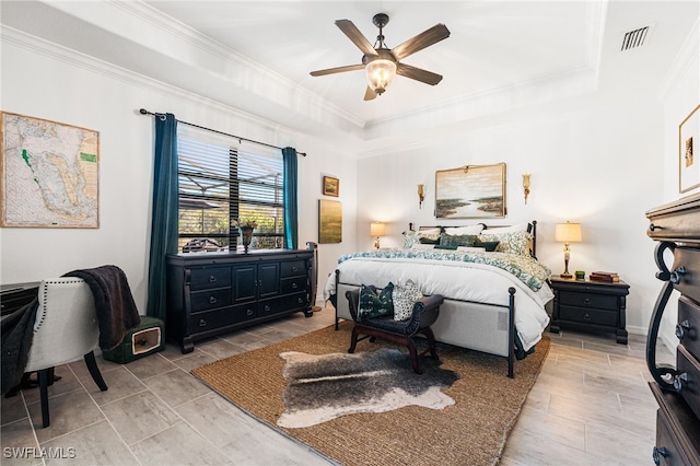 bedroom with visible vents, a raised ceiling, a ceiling fan, and crown molding