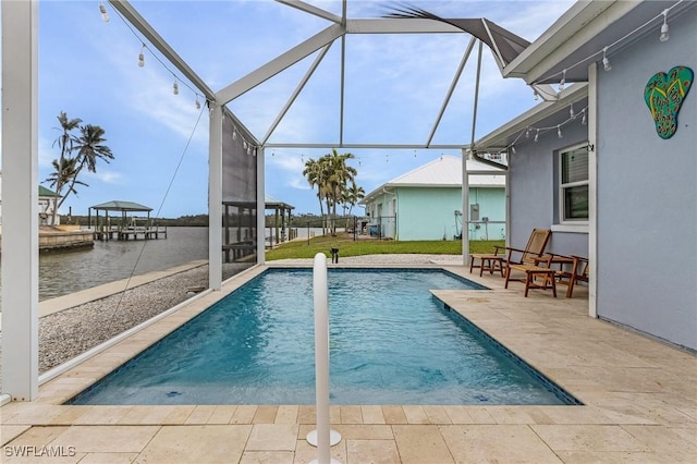 outdoor pool with glass enclosure and a patio