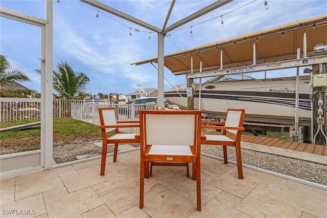 view of patio / terrace featuring fence and a dock