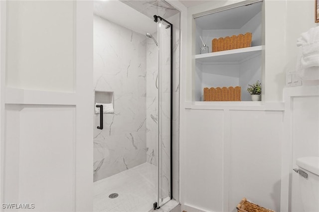 full bathroom featuring a marble finish shower and toilet