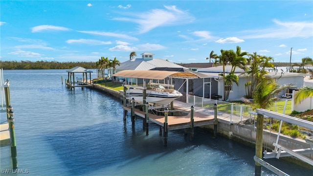 dock area featuring fence, a water view, and boat lift