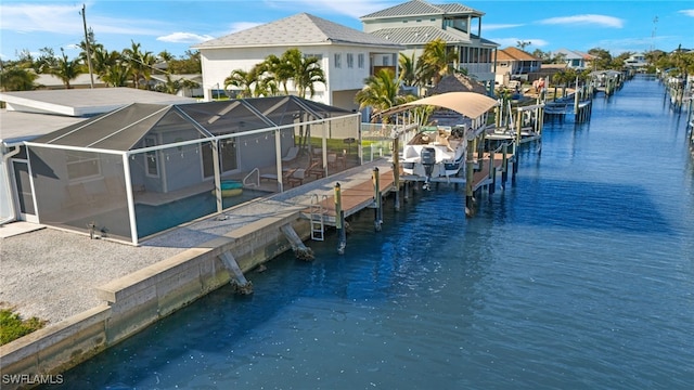 view of dock with a residential view, a water view, boat lift, and a lanai