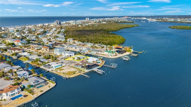 drone / aerial view with a water view and a residential view