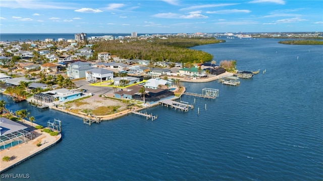 birds eye view of property with a water view and a residential view