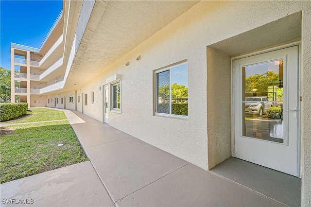 exterior space featuring a lawn and stucco siding