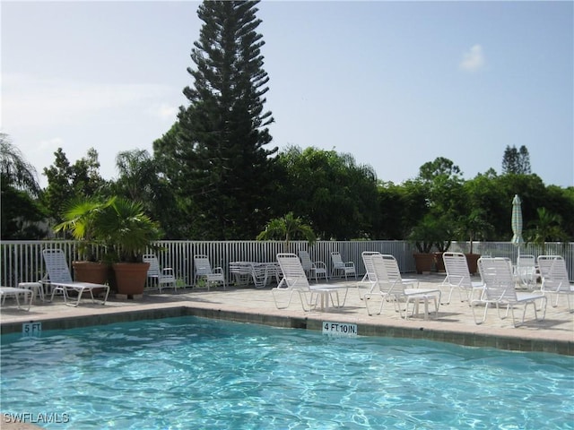 community pool featuring a patio area and fence