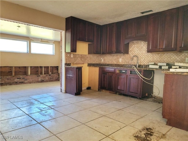 kitchen with a sink, visible vents, and backsplash