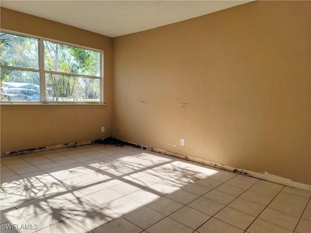 spare room with light tile patterned floors