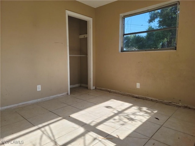 spare room featuring baseboards