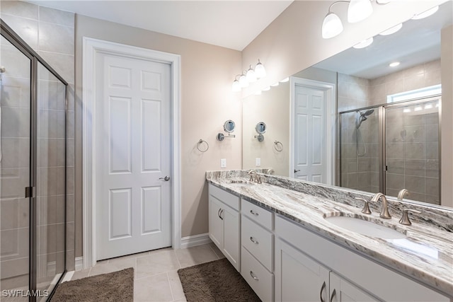 full bath featuring tile patterned flooring, a sink, a shower stall, and double vanity