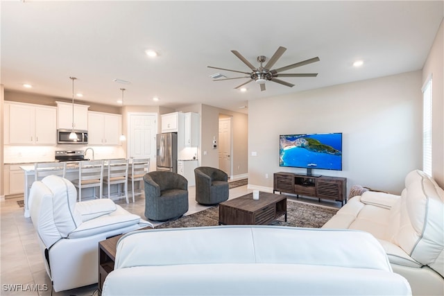 living room with light tile patterned floors, recessed lighting, visible vents, a ceiling fan, and baseboards