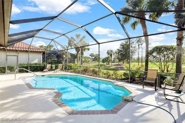 pool featuring glass enclosure and a patio area