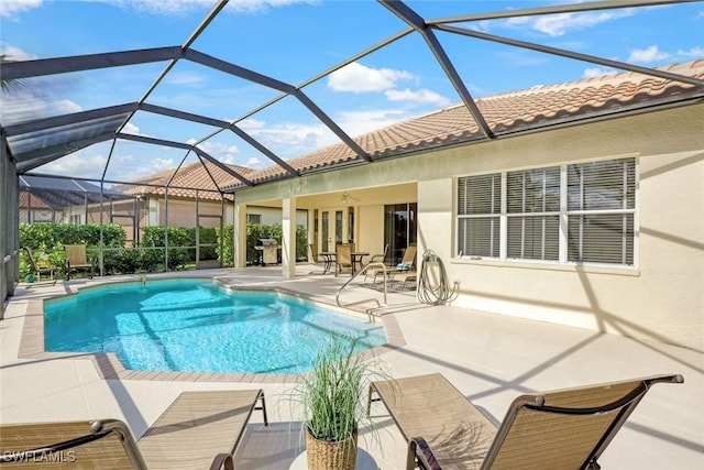 outdoor pool with a ceiling fan, a patio, glass enclosure, and french doors