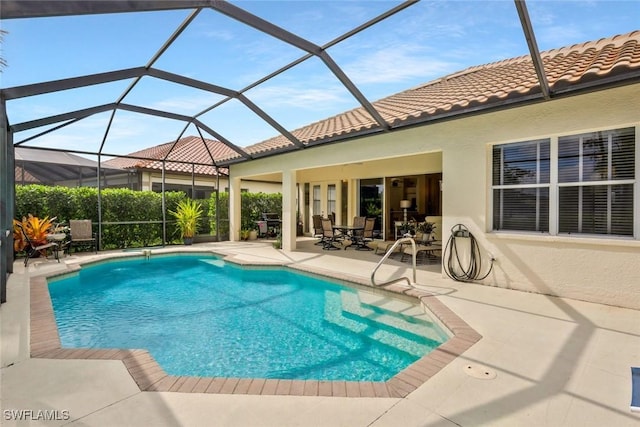 12604 Wildcat Cove Cir, Estero, FL 33928 - view of swimming pool featuring glass enclosure, a fenced in pool, and a patio
