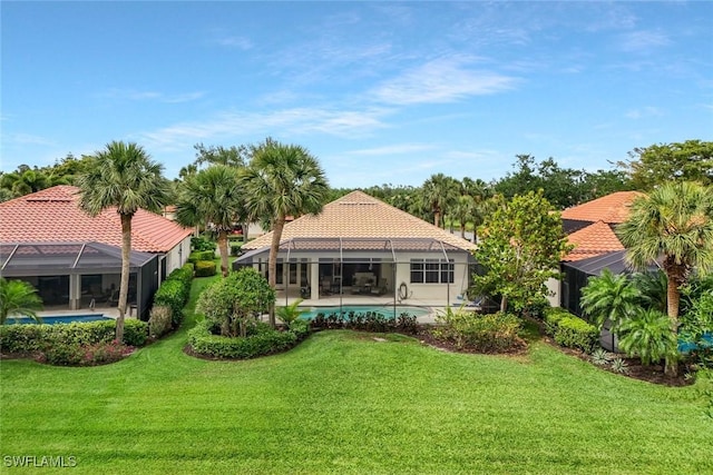 12604 Wildcat Cove Cir, Estero, FL 33928 - rear view of house with glass enclosure, a lawn, and a tile roof