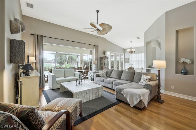 12604 Wildcat Cove Cir, Estero, FL 33928 - living area with ceiling fan with notable chandelier, wood finished floors, visible vents, and a healthy amount of sunlight