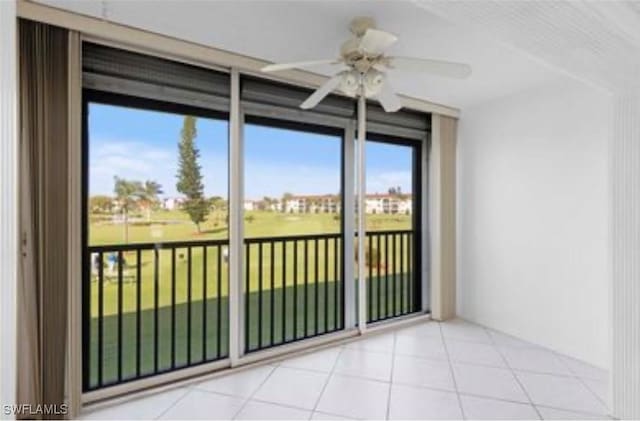 unfurnished room with tile patterned flooring and a ceiling fan