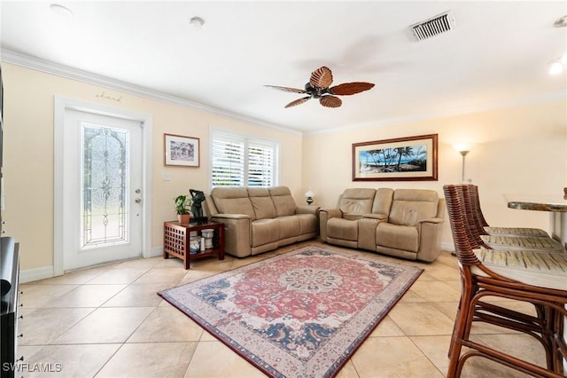 living area with visible vents, light tile patterned flooring, ornamental molding, and a ceiling fan
