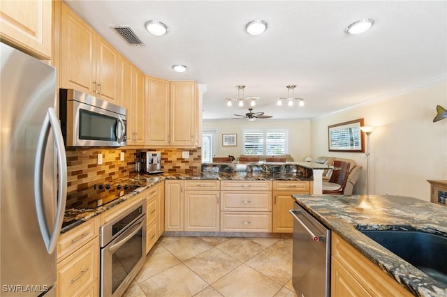 kitchen featuring visible vents, appliances with stainless steel finishes, and light brown cabinetry