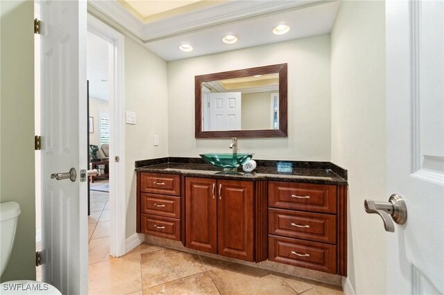 half bath featuring vanity, tile patterned floors, toilet, and recessed lighting