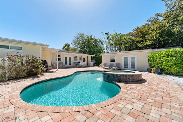 view of swimming pool with a patio area, central air condition unit, french doors, and a pool with connected hot tub