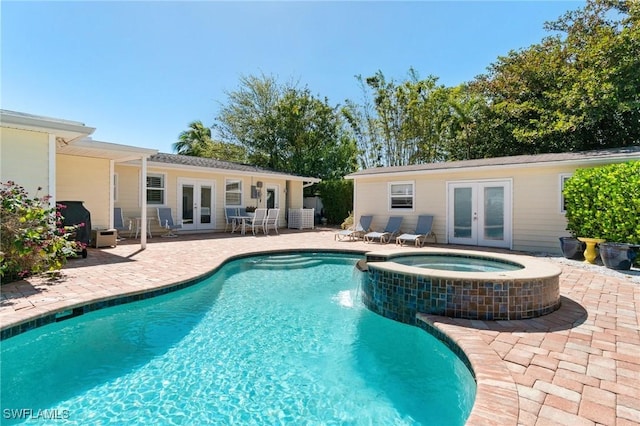 view of swimming pool featuring french doors, a pool with connected hot tub, and a patio area