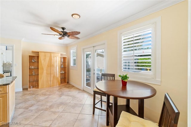 dining room with ceiling fan, baseboards, plenty of natural light, and ornamental molding