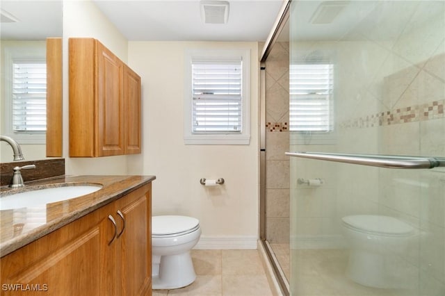 bathroom with visible vents, toilet, a shower stall, tile patterned flooring, and vanity
