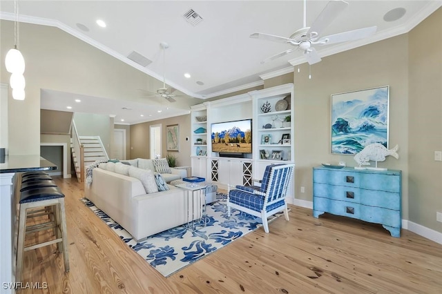 living area featuring visible vents, crown molding, and wood finished floors