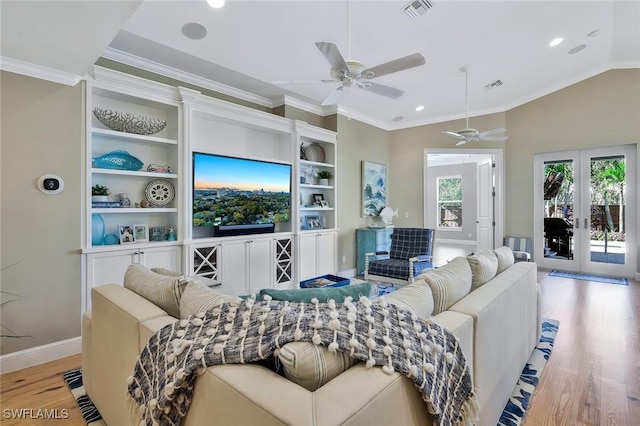 living room with lofted ceiling, wood finished floors, visible vents, and crown molding