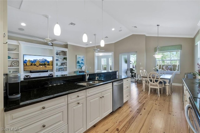 kitchen with light wood finished floors, lofted ceiling, ornamental molding, a sink, and stainless steel dishwasher