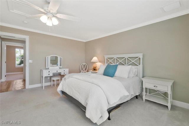 carpeted bedroom with ceiling fan, ornamental molding, and baseboards