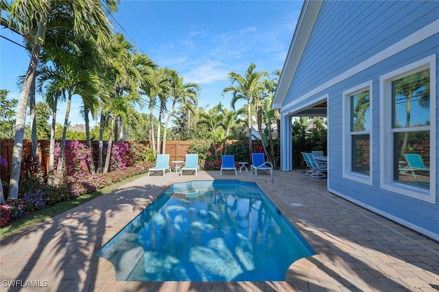 view of swimming pool featuring a patio area, a fenced backyard, and a fenced in pool