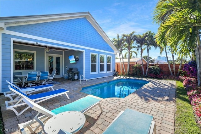 view of pool featuring ceiling fan, a patio, a fenced backyard, french doors, and a fenced in pool