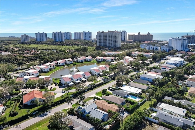 birds eye view of property featuring a water view and a view of city